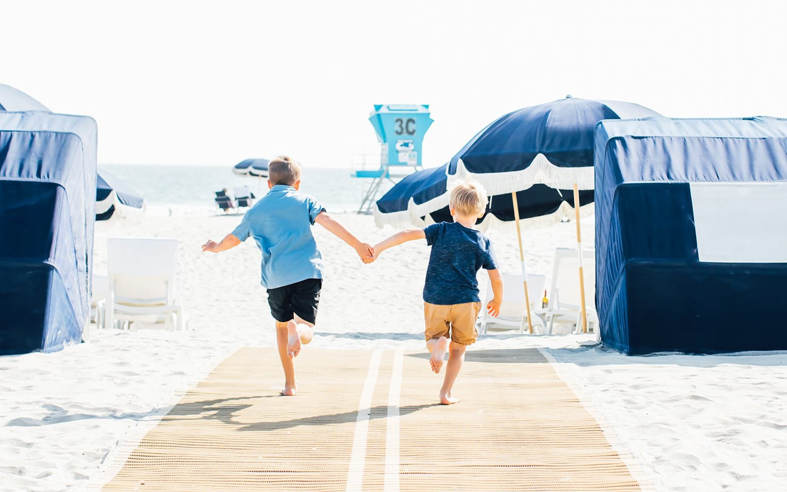 Kids running on the beach at The Beach Club